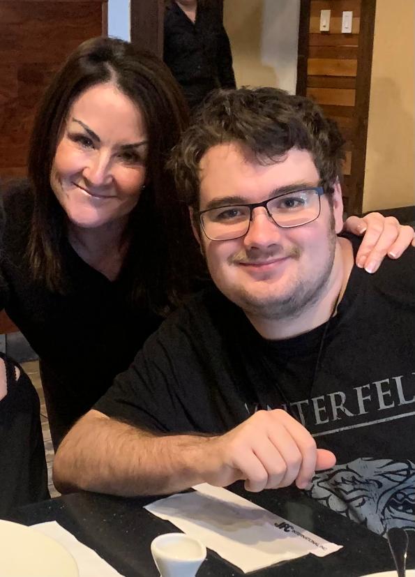 Laura and Chris smiling together at a table.